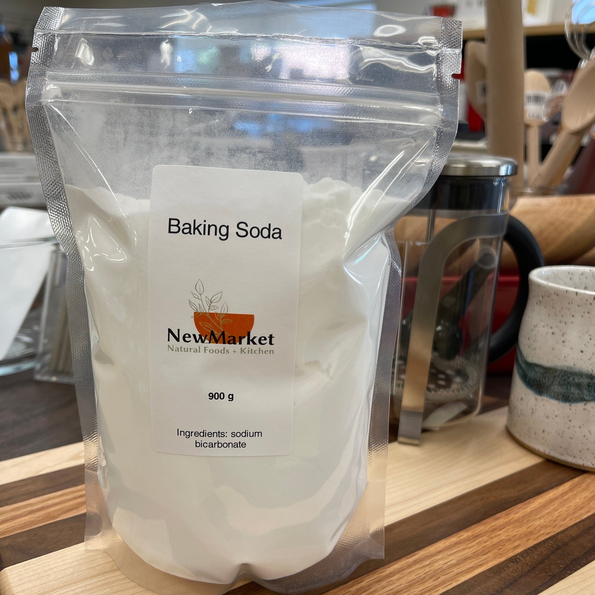 Bag of baking soda with a label on a wooden surface