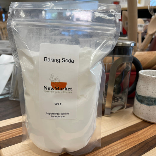 Bag of baking soda with a label on a wooden surface
