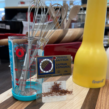 Small package, .25g of Spanish saffron on a wooden cutting board.