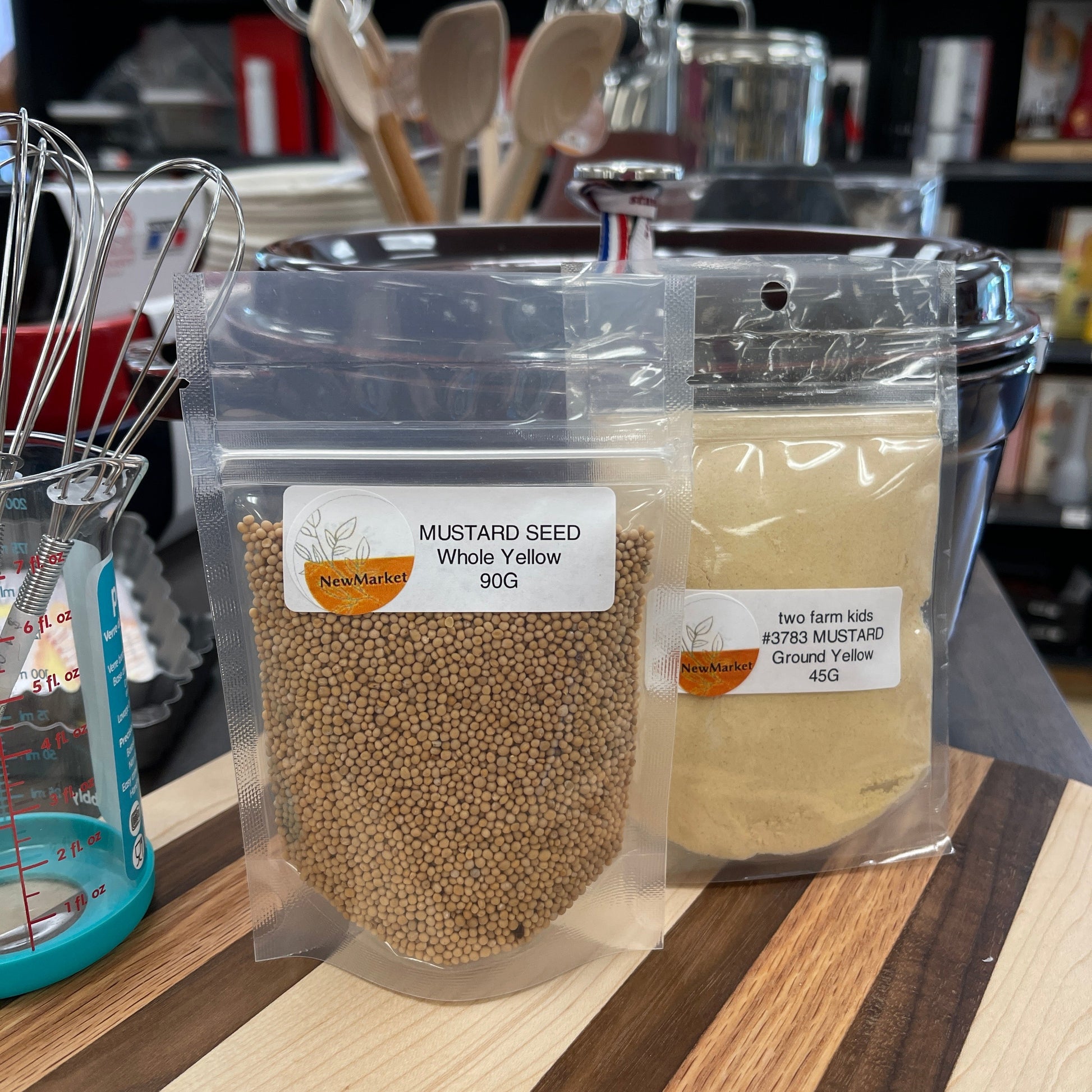 Packaged mustard seed on a shelf with kitchen items in the background
