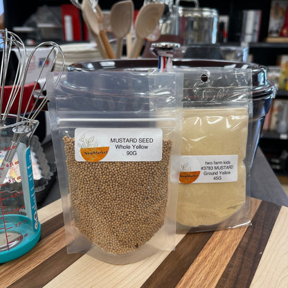 Packaged mustard seed on a shelf with kitchen items in the background