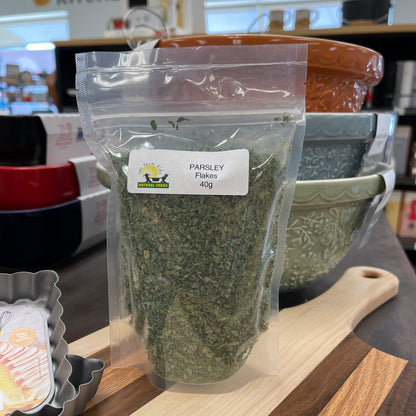 Package of Parsley Flakes, 40g, sitting on cutting board.