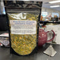 Herbal product packaging with a label on a dark surface