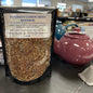 Package of tunisian lemon mint rooibos tea on a table with teapots and tea diffusers.