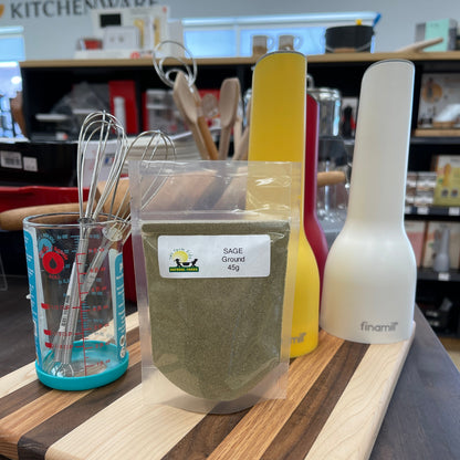 Wooden cutting board with a package of ground sage.