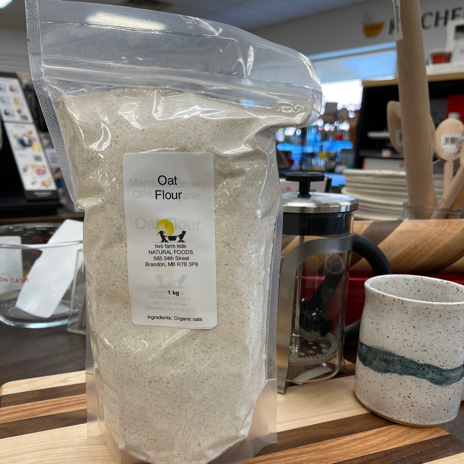 Bag of oat flour with a label on a wooden surface