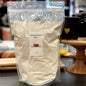 Bag of whole wheat flour with NewMarket label on a kitchen counter